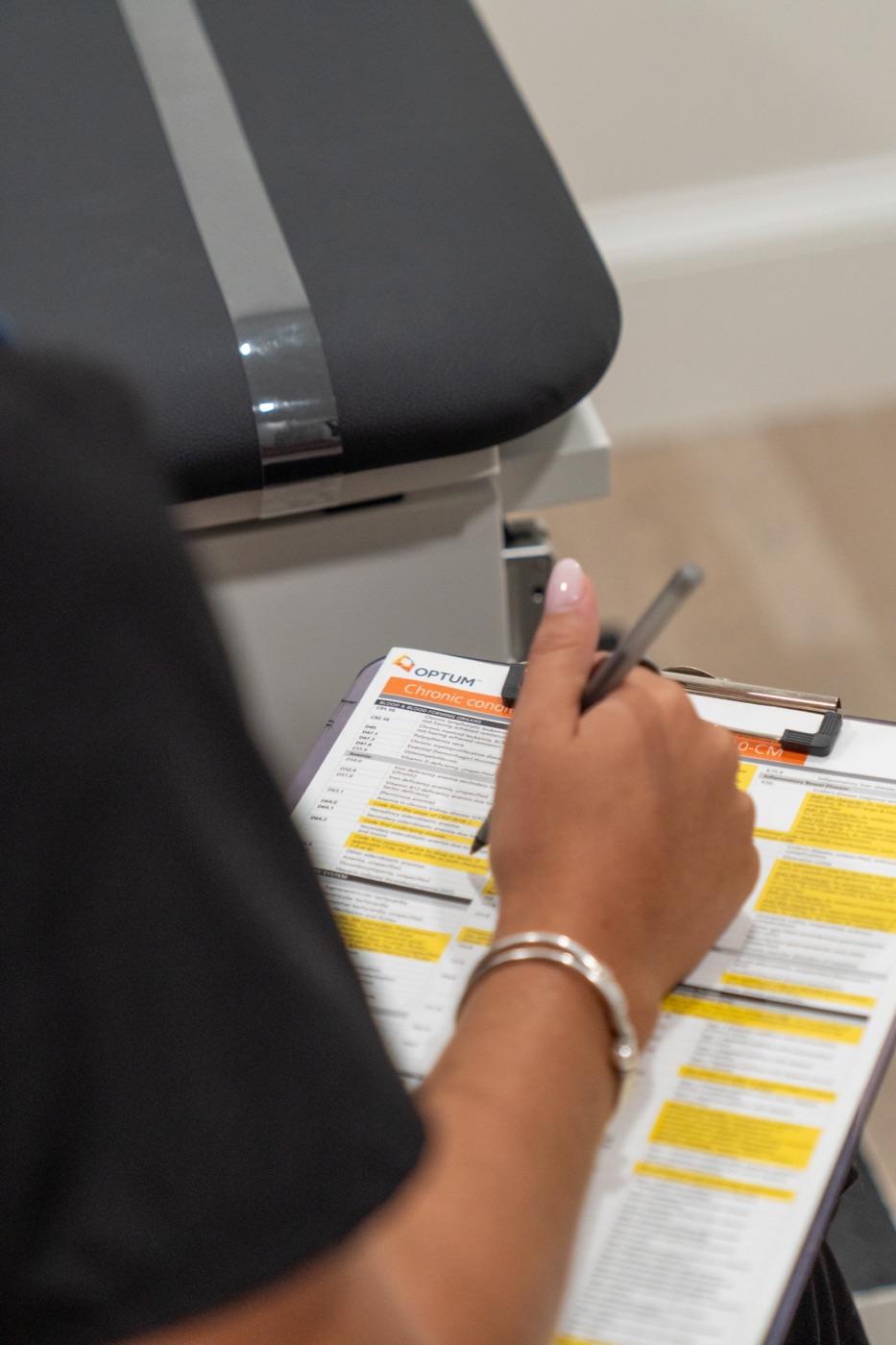 Home health aide completing a patient care chart